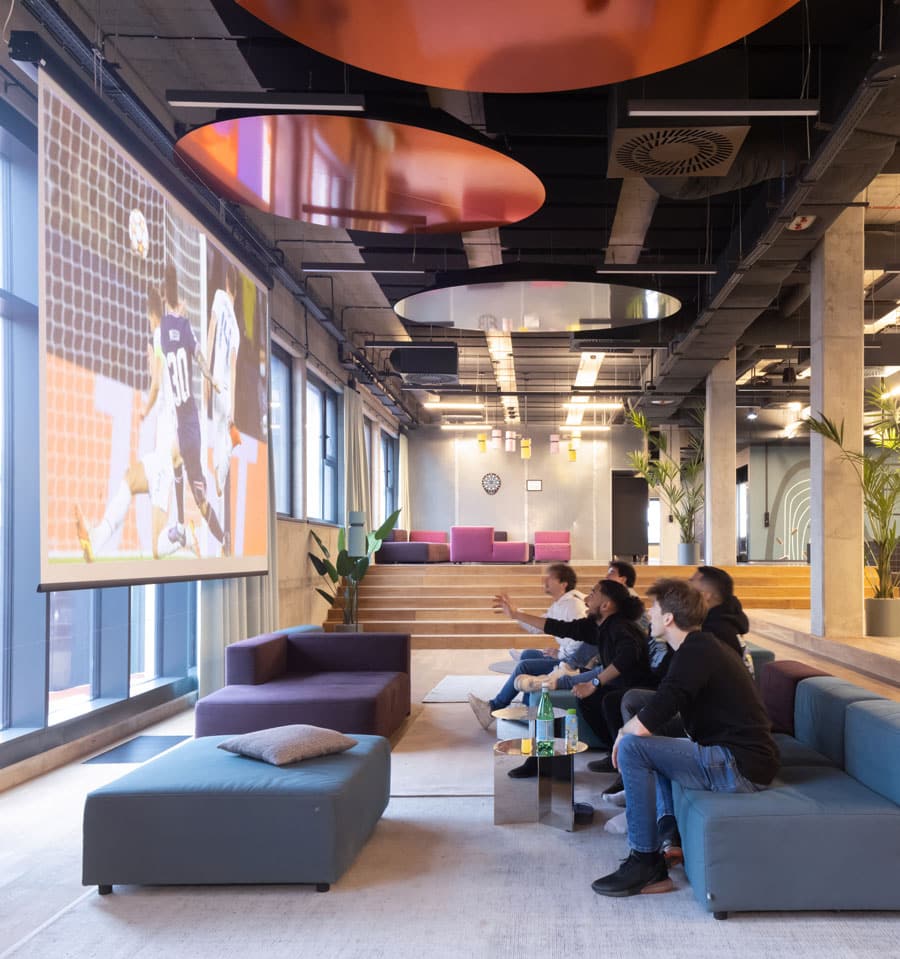 Students watching football at Basecamp Łódź Rembielilnskiego student accommodation cinema room